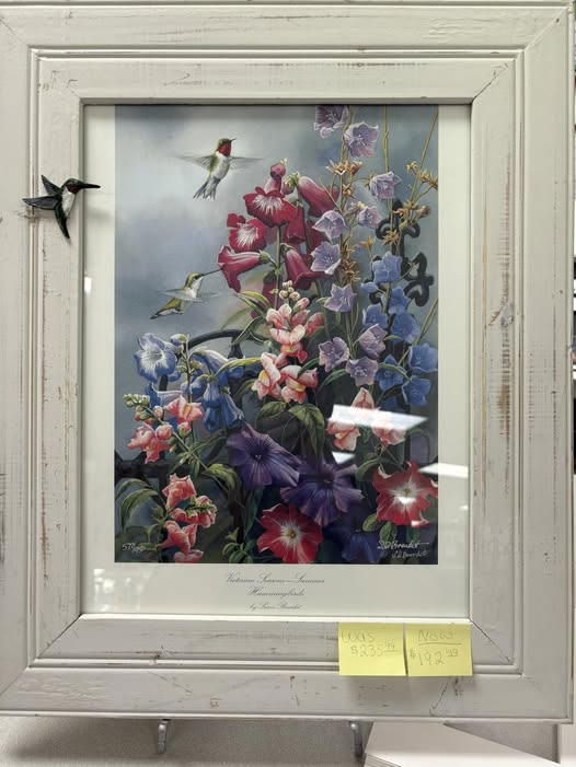 Hummingbird and wildflower print in a distressed white wood frame