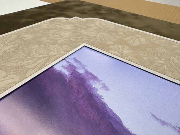 Close-up of a textured mat corner cut for a purple landscape print