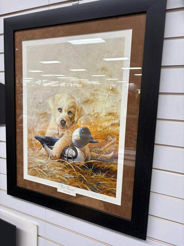 Framed print of a yellow Labrador puppy with duck decoys, double-matted in tan and black