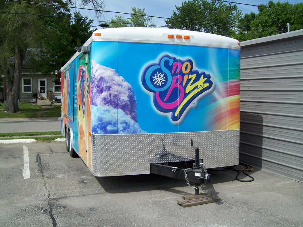 Rear of the SnoBiz shaved ice trailer, hitched and ready to tow