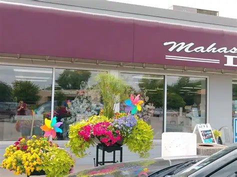 Mahaska Drug storefront with flower planters along the sidewalk