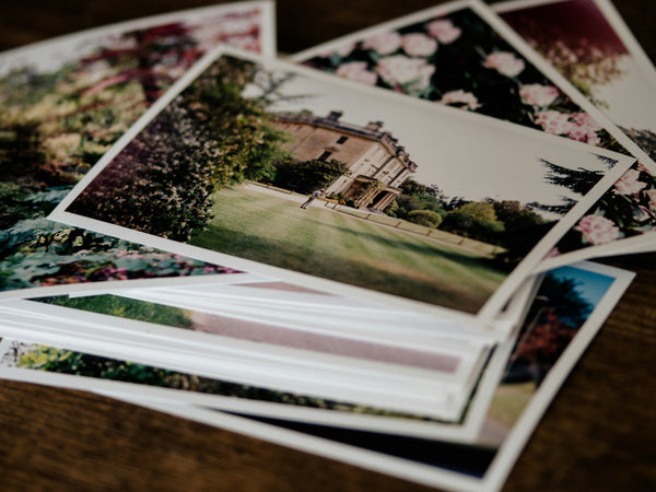 Photo prints fanned out in a stack, ready for pickup