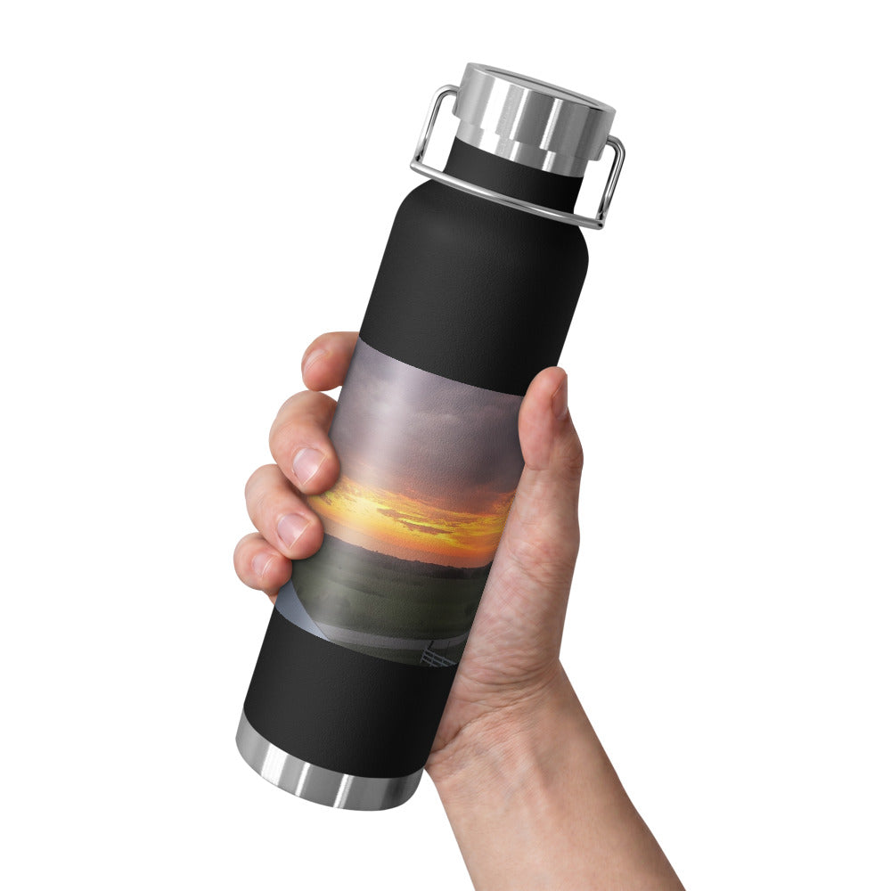 Insulated Water Bottle (22 oz) shown with an Iowa sunset photo printed on it