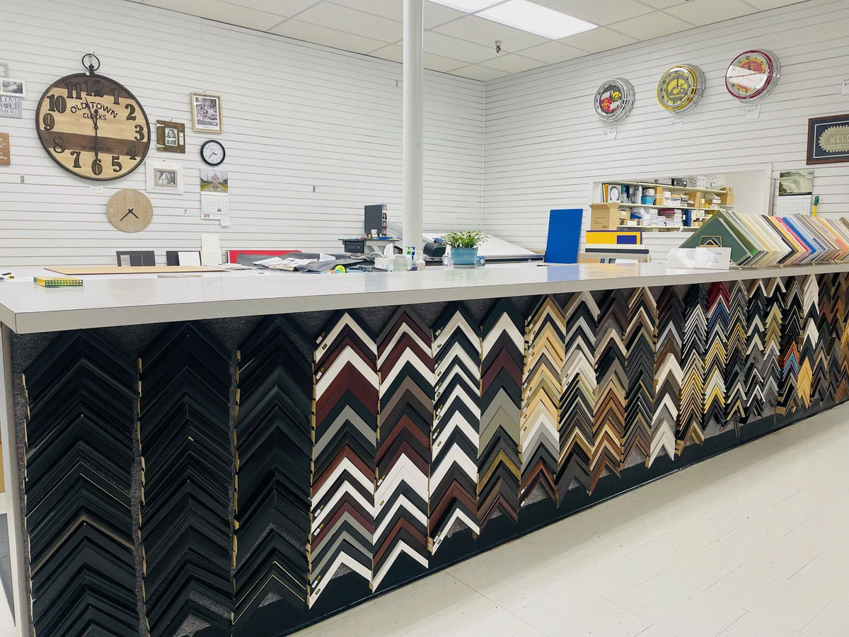 Custom framing counter at Mahaska Drug with wall of frame corner samples
