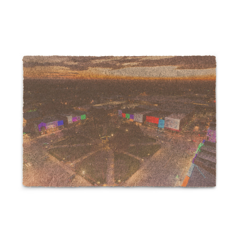 Custom photo coir doormat, 24 by 16 inches, with a customer photo printed on the front, lying at a covered front door