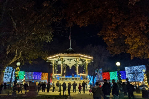 Crowd at the City Square Park bandstand under the Painting with Lights display